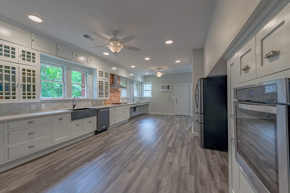 Inspiration for a large rustic galley dark wood floor eat-in kitchen remodel in Austin with a farmhouse sink, open cabinets, white cabinets, quartzite countertops, multicolored backsplash, marble backsplash, stainless steel appliances and no island