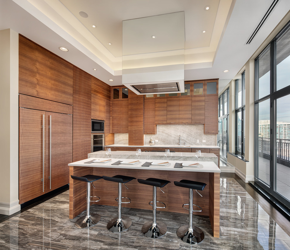 Design ideas for a mid-sized contemporary l-shaped eat-in kitchen in Chicago with an undermount sink, flat-panel cabinets, medium wood cabinets, white splashback, stainless steel appliances and multiple islands.