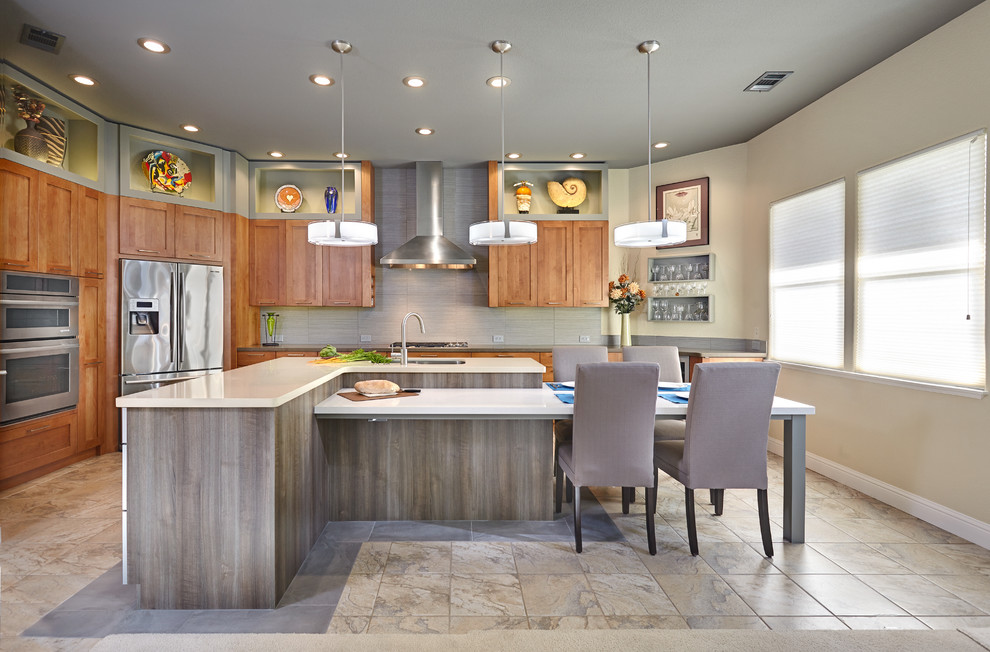 Photo of a large transitional l-shaped eat-in kitchen in Other with an undermount sink, shaker cabinets, medium wood cabinets, quartz benchtops, grey splashback, porcelain splashback, stainless steel appliances, porcelain floors and with island.
