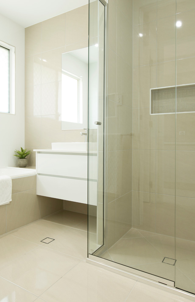 Design ideas for a small contemporary master bathroom in Townsville with a drop-in sink, flat-panel cabinets, white cabinets, engineered quartz benchtops, a drop-in tub, an alcove shower, beige tile, ceramic tile, white walls and ceramic floors.