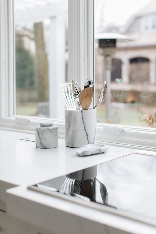 Example of a mid-sized transitional dark wood floor and brown floor eat-in kitchen design in Chicago with a farmhouse sink, beaded inset cabinets, white cabinets, quartz countertops, paneled appliances, an island and white countertops