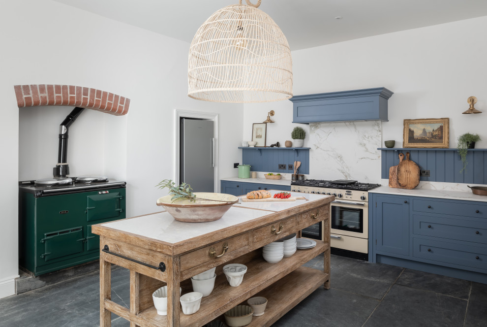 Inspiration for a large traditional enclosed kitchen in Devon with recessed-panel cabinets, blue cabinets, quartz worktops, blue splashback, coloured appliances, an island and grey floors.