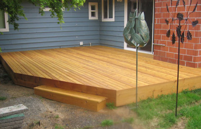 Example of a mid-sized backyard deck design in Seattle with no cover
