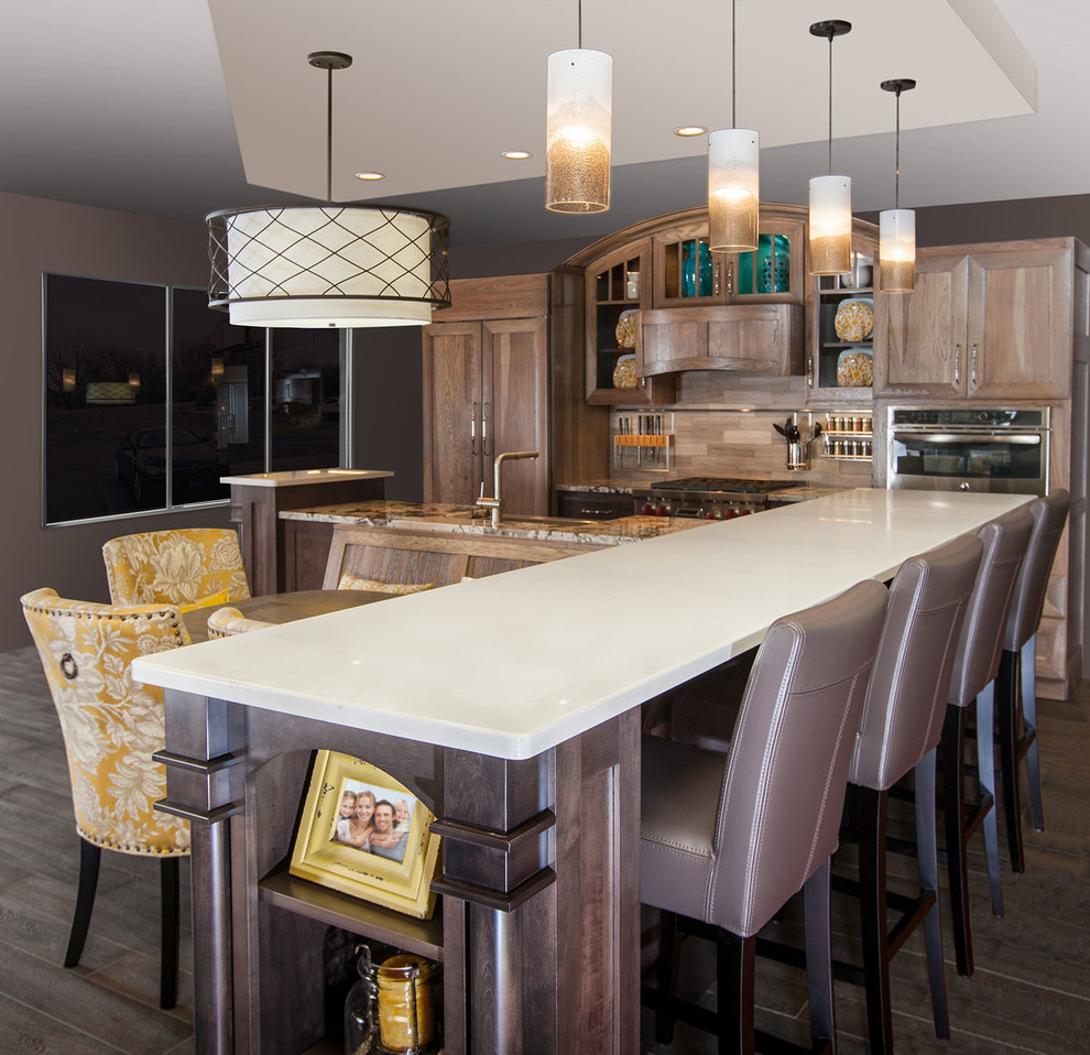 Design ideas for a large traditional galley eat-in kitchen in Minneapolis with a farmhouse sink, recessed-panel cabinets, medium wood cabinets, granite benchtops, beige splashback, porcelain splashback, stainless steel appliances, porcelain floors and with island.