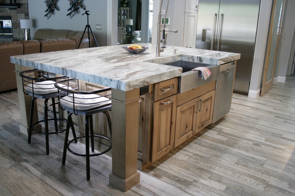 Design ideas for a large country l-shaped open plan kitchen in Orlando with a farmhouse sink, raised-panel cabinets, white cabinets, quartzite benchtops, brown splashback, glass tile splashback, stainless steel appliances, porcelain floors and with island.