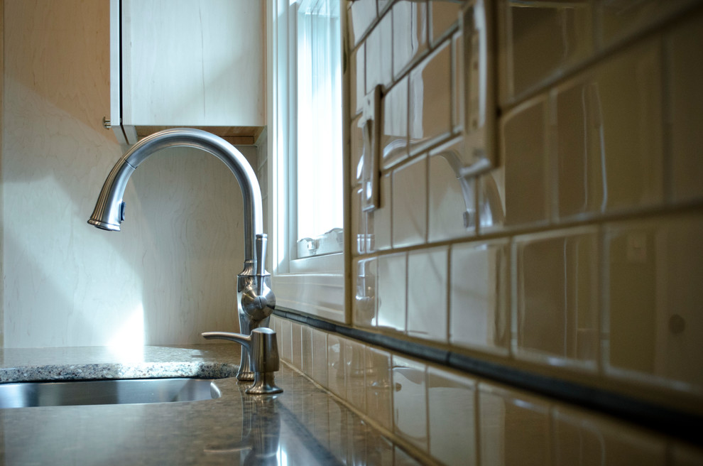 Inspiration for a small transitional galley laminate floor and red floor eat-in kitchen remodel in Chicago with an undermount sink, shaker cabinets, light wood cabinets, quartz countertops, white backsplash, subway tile backsplash, stainless steel appliances and no island