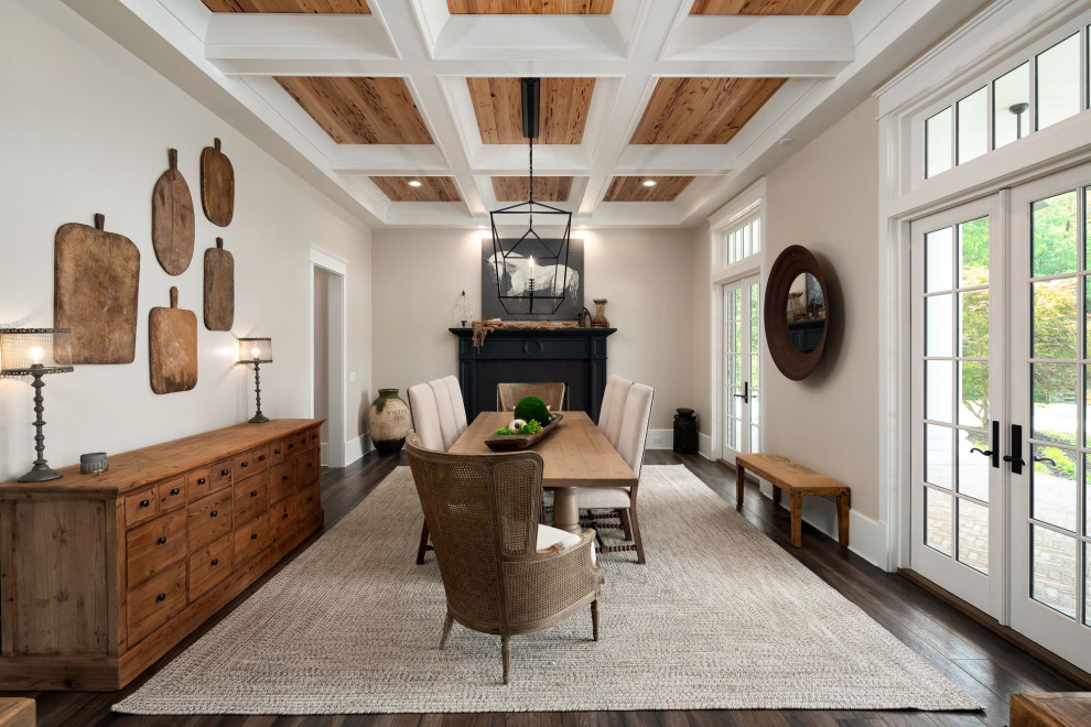 Design ideas for a country dining room in Atlanta with beige walls, dark hardwood floors, a standard fireplace, brown floor and coffered.