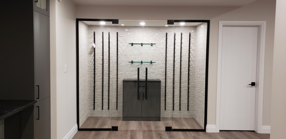 Basement - large transitional walk-out vinyl floor basement idea with a bar