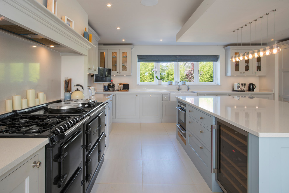 Design ideas for a contemporary kitchen in West Midlands with a single-bowl sink, shaker cabinets, limestone benchtops, limestone splashback, porcelain floors, a peninsula and grey floor.