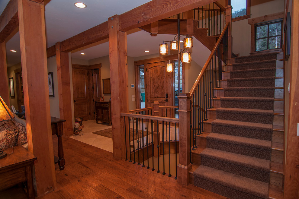 Inspiration for a large country carpeted curved staircase in Denver with carpet risers.