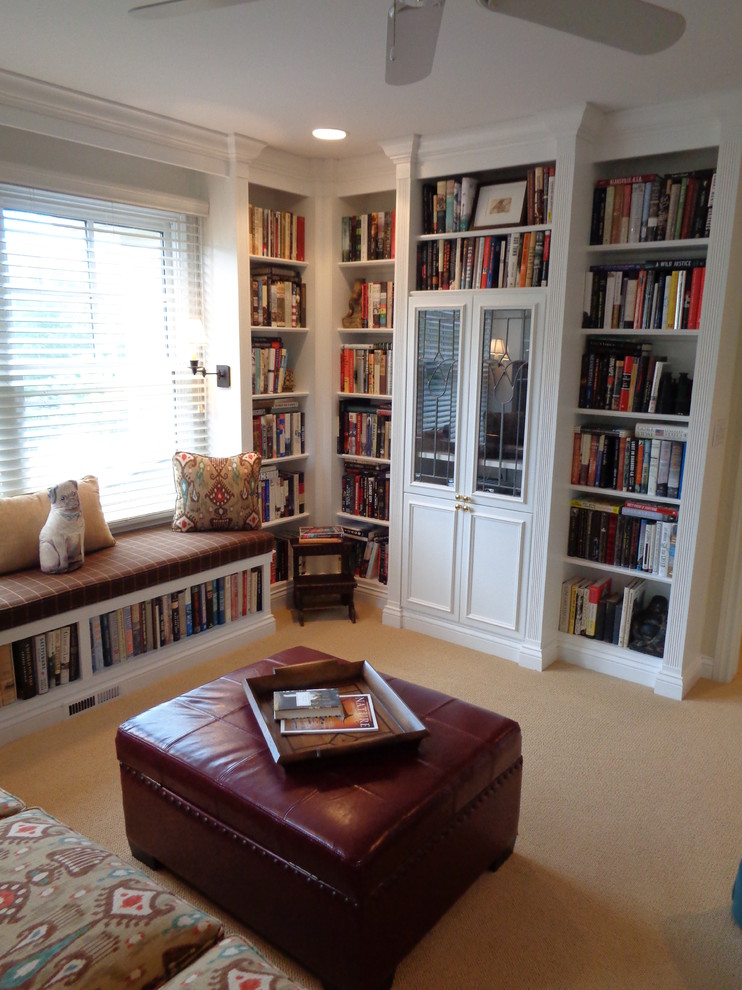 This is an example of a small traditional enclosed family room in Baltimore with a library, carpet, no fireplace and a concealed tv.