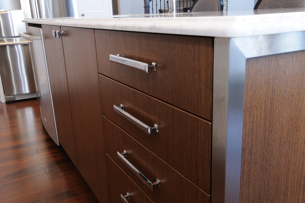 Example of a mid-sized transitional l-shaped dark wood floor eat-in kitchen design in Calgary with an undermount sink, flat-panel cabinets, medium tone wood cabinets, quartz countertops and stainless steel appliances