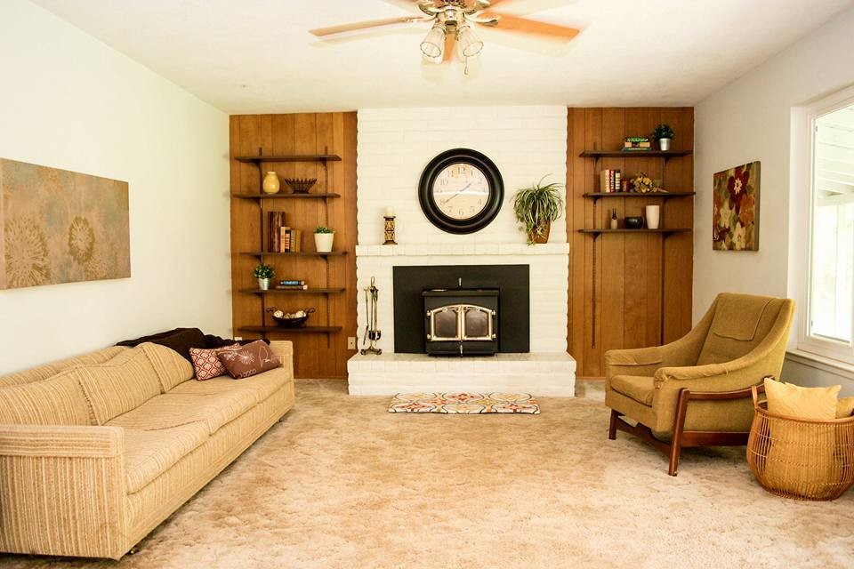 Design ideas for a mid-sized traditional enclosed family room in Sacramento with white walls, carpet, a standard fireplace, a brick fireplace surround and beige floor.