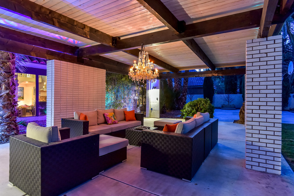 This is an example of a large midcentury backyard patio in Las Vegas with concrete slab and a gazebo/cabana.