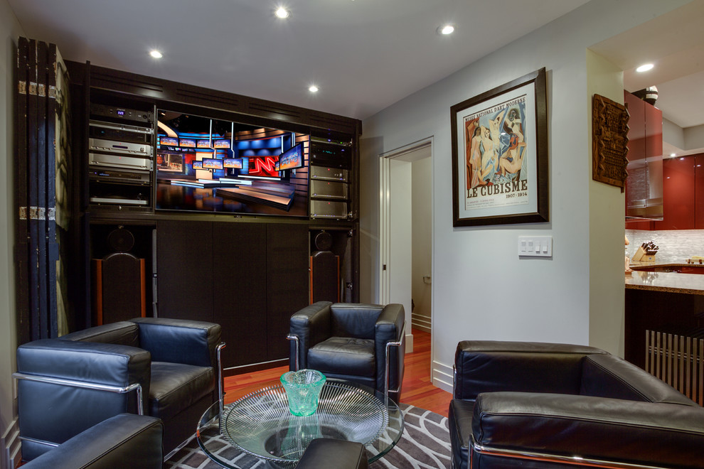 Photo of a small contemporary enclosed home theatre in DC Metro with grey walls, dark hardwood floors and a built-in media wall.
