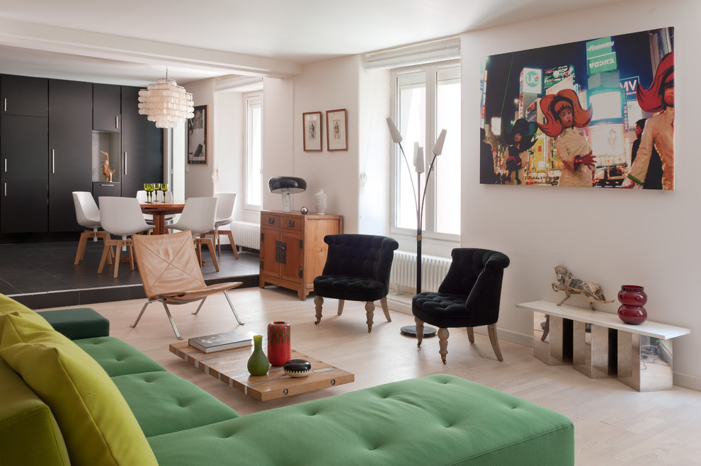 Design ideas for a large eclectic open concept living room in Paris with white walls, light hardwood floors and no tv.