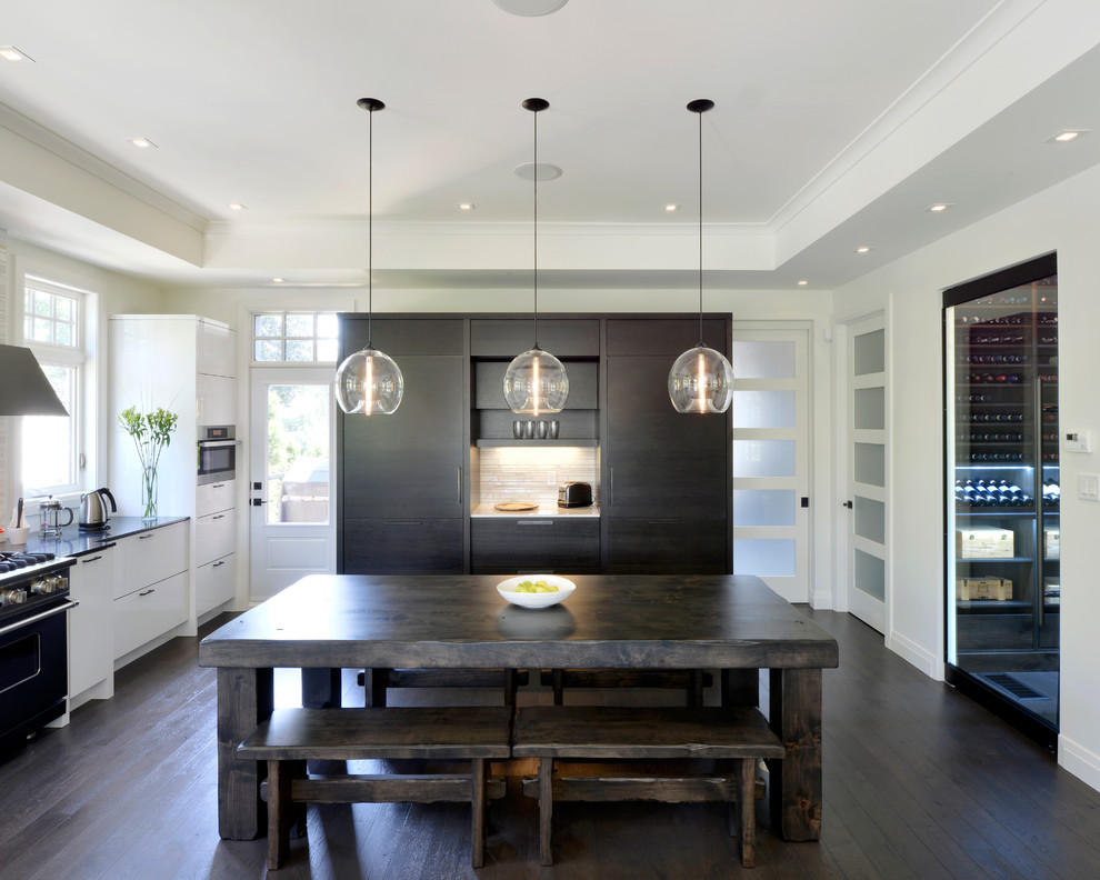 Contemporary u-shaped eat-in kitchen in Toronto with flat-panel cabinets, white cabinets and black appliances.