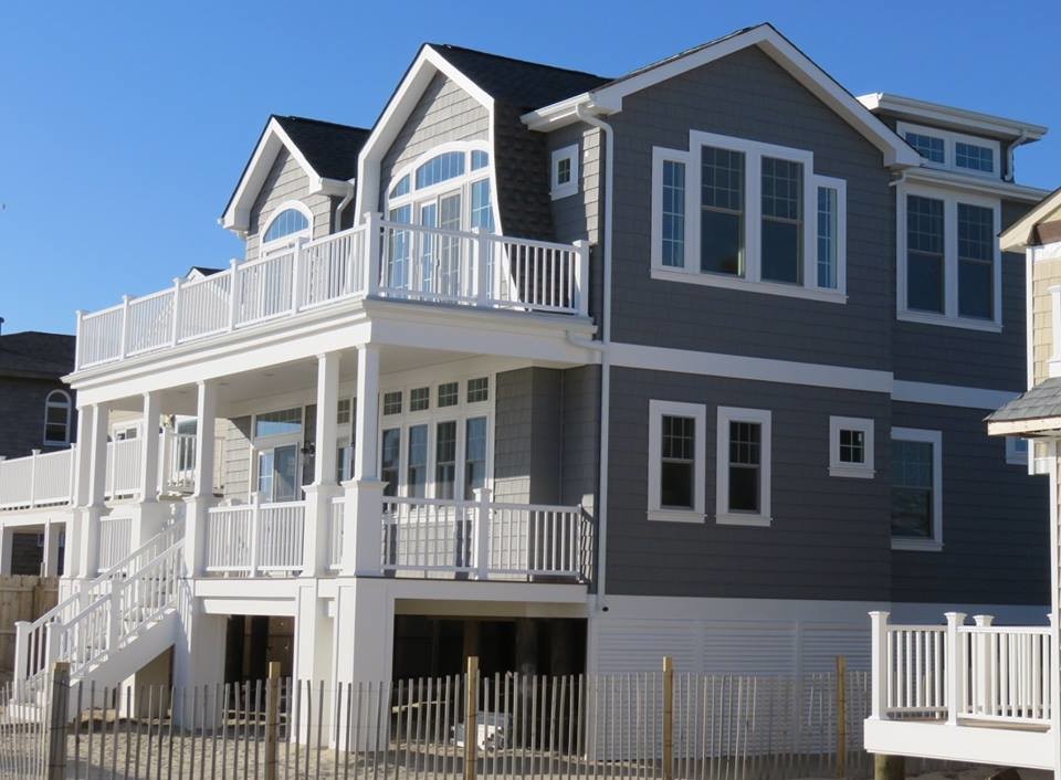 Beach style two-storey grey exterior in New York with concrete fiberboard siding.