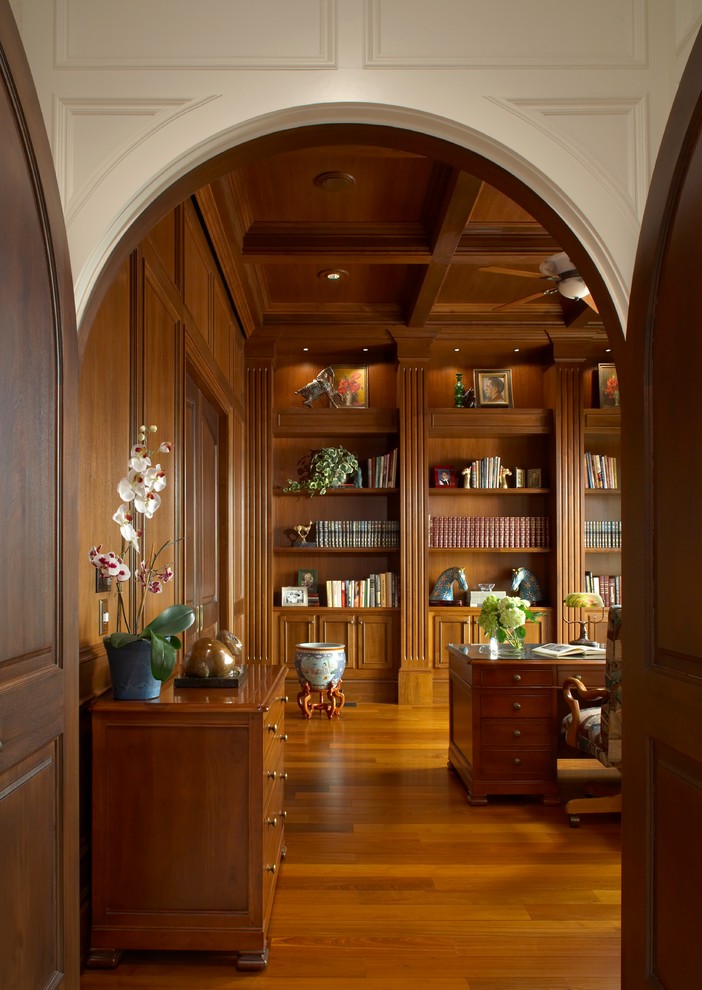 Design ideas for a traditional study room in Detroit with medium hardwood floors and a freestanding desk.