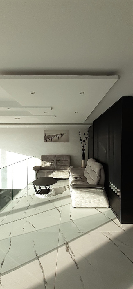This is an example of a large contemporary foyer in Other with white walls, ceramic floors, white floor and recessed.