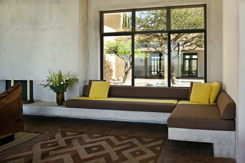 Mediterranean living room in New York with brick floors.