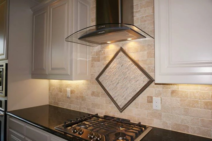 Inspiration for a mid-sized transitional enclosed kitchen remodel in New York with raised-panel cabinets, white cabinets, granite countertops, beige backsplash and stone tile backsplash