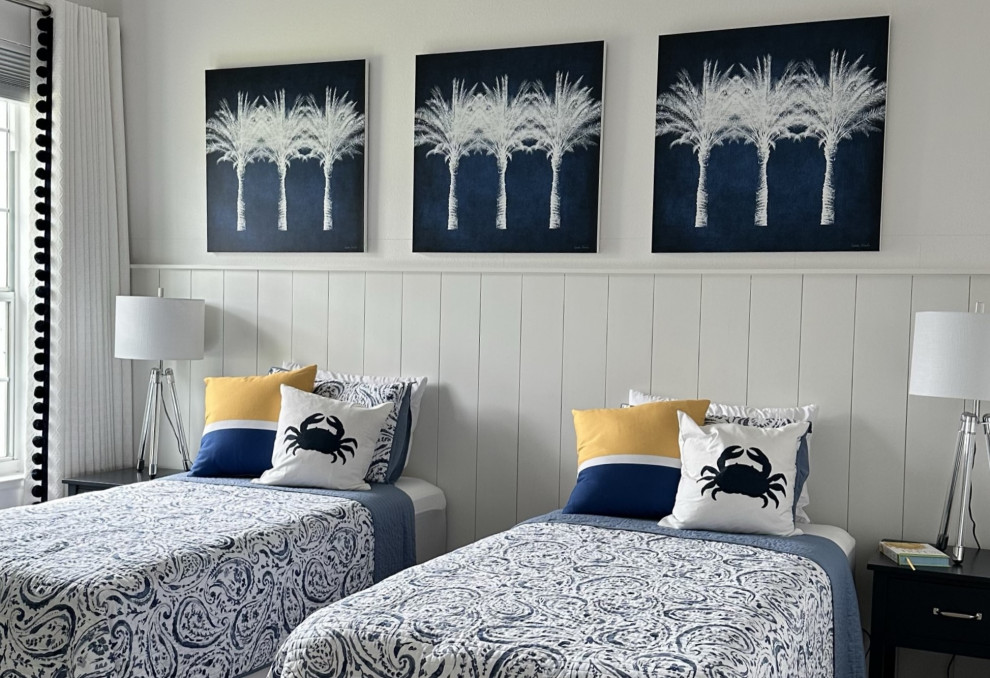 This is an example of a beach style guest bedroom in Orlando with white walls.