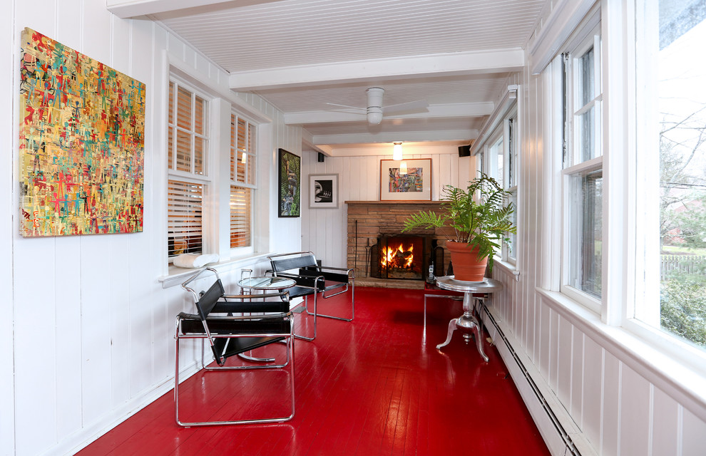 This is an example of a transitional sunroom in Philadelphia with red floor.