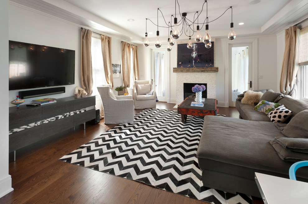 Inspiration for a large modern enclosed family room in New York with white walls, dark hardwood floors, a standard fireplace, no tv and a stone fireplace surround.