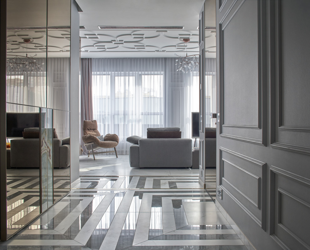Inspiration for a large contemporary vestibule in Yekaterinburg with grey walls, porcelain floors, a single front door, a dark wood front door, grey floor, recessed and panelled walls.