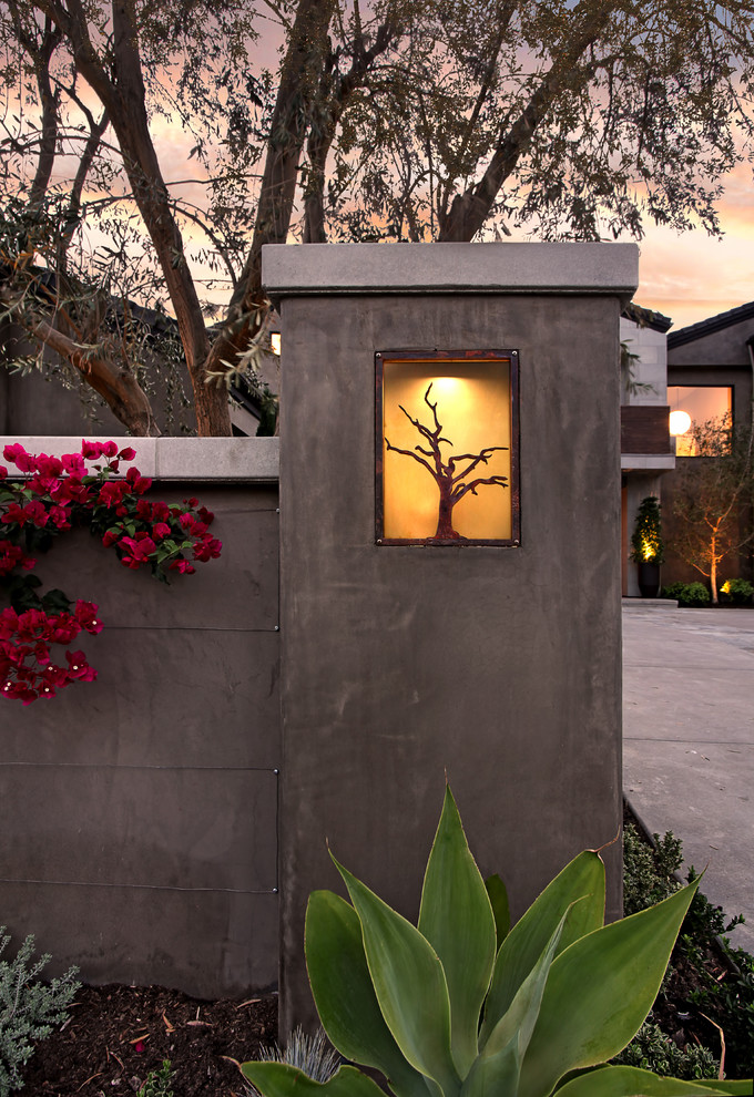 This is an example of a large contemporary two-storey concrete grey exterior in Orange County with a gable roof.