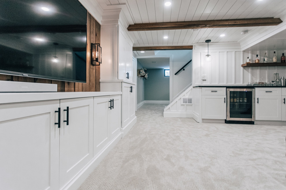 Inspiration for a mid-sized country fully buried basement in Minneapolis with a home bar, white walls, carpet, grey floor, wood and panelled walls.