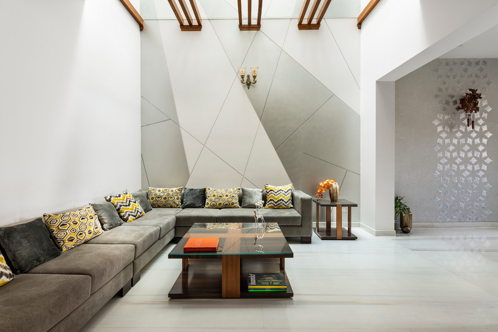 This is an example of a contemporary open concept living room in Delhi with white walls and white floor.