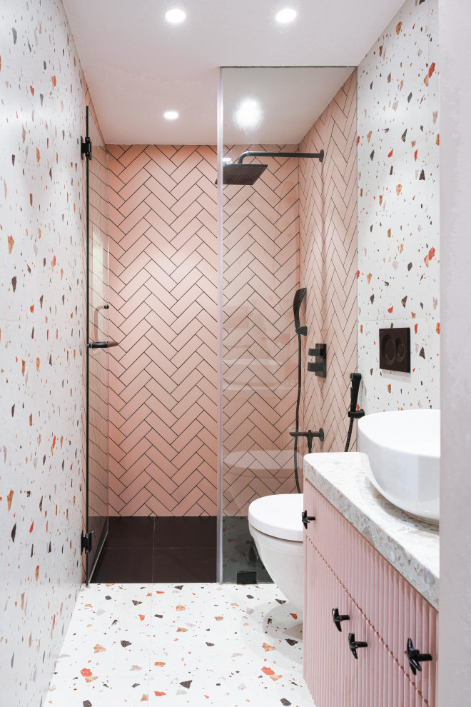 Mid-sized traditional kids wet room bathroom in Mumbai with furniture-like cabinets, white cabinets, a wall-mount toilet, white tile, subway tile, white walls, ceramic floors, a vessel sink, terrazzo benchtops, white floor, a hinged shower door, white benchtops, an enclosed toilet, a single vanity and a built-in vanity.