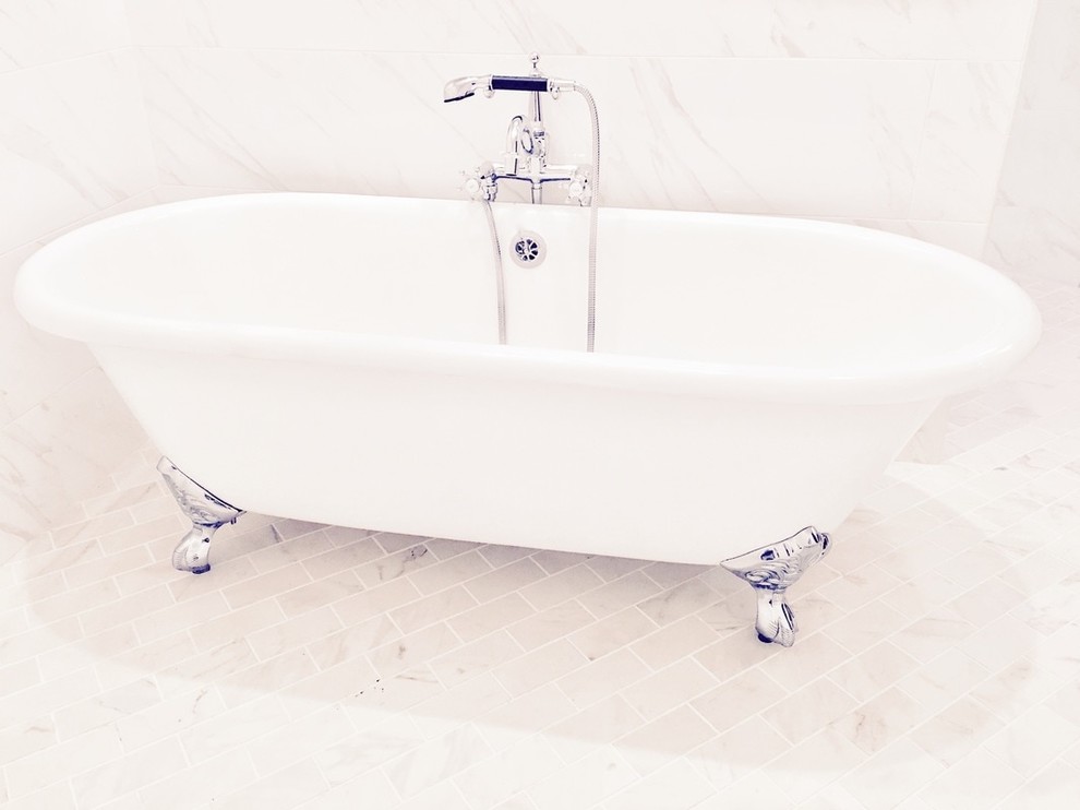 Claw-foot bathtub - large transitional white tile and porcelain tile marble floor claw-foot bathtub idea with white cabinets, a one-piece toilet, white walls, an undermount sink and marble countertops