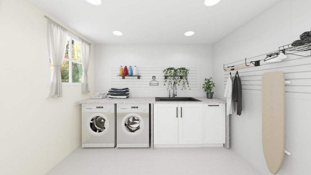 Photo of a large traditional single-wall dedicated laundry room in Toronto with a drop-in sink, recessed-panel cabinets, white cabinets, white walls, a side-by-side washer and dryer, panelled walls, white splashback and grey benchtop.