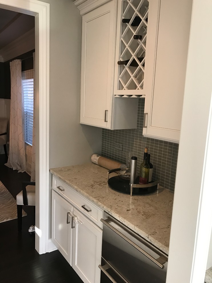 Example of a large transitional l-shaped light wood floor and multicolored floor eat-in kitchen design in Chicago with beaded inset cabinets, white cabinets, quartz countertops, black backsplash, ceramic backsplash, stainless steel appliances and an island