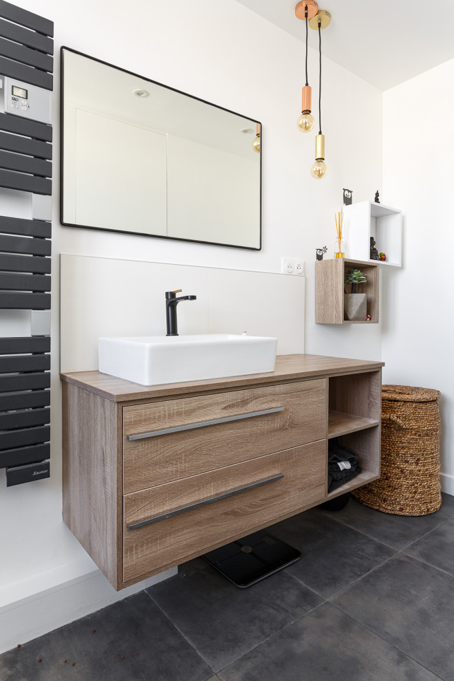 Inspiration for a large contemporary master bathroom in Paris with flat-panel cabinets, brown cabinets, an alcove tub, a shower/bathtub combo, black tile, ceramic tile, white walls, ceramic floors, a vessel sink, wood benchtops, grey floor, a hinged shower door, brown benchtops, a single vanity and a floating vanity.