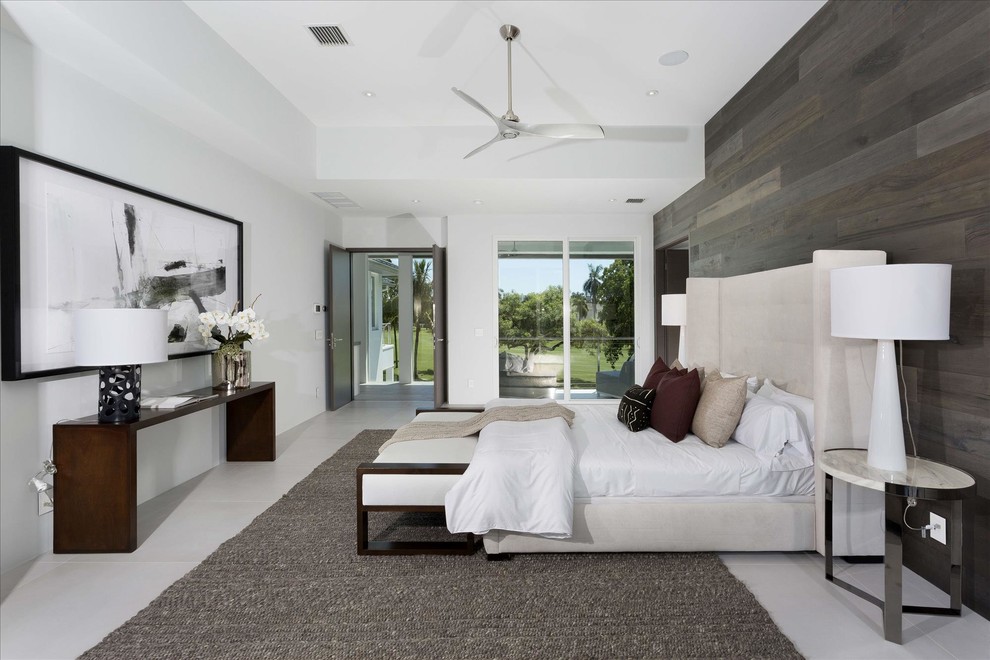 Design ideas for a large contemporary master bedroom in Miami with white walls, concrete floors and no fireplace.
