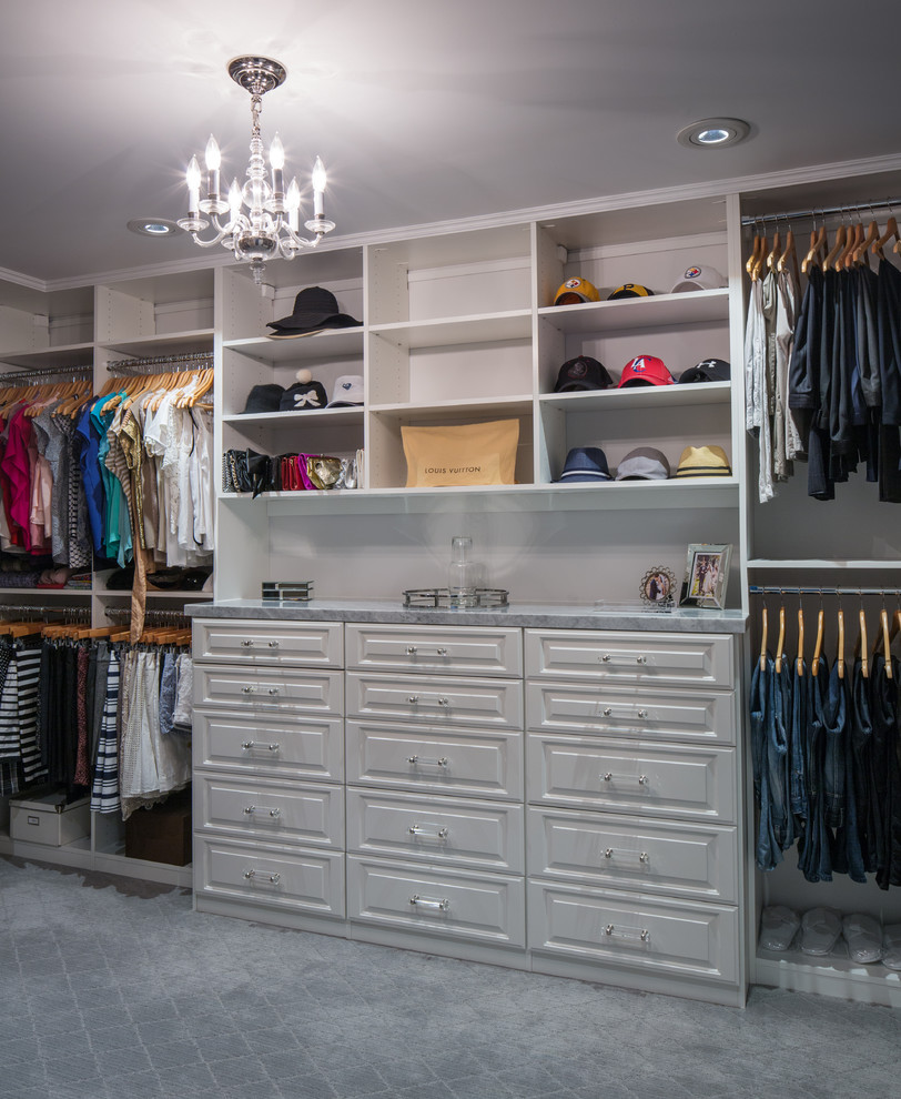 Photo of a mid-sized arts and crafts gender-neutral walk-in wardrobe in Los Angeles with white cabinets, carpet and raised-panel cabinets.