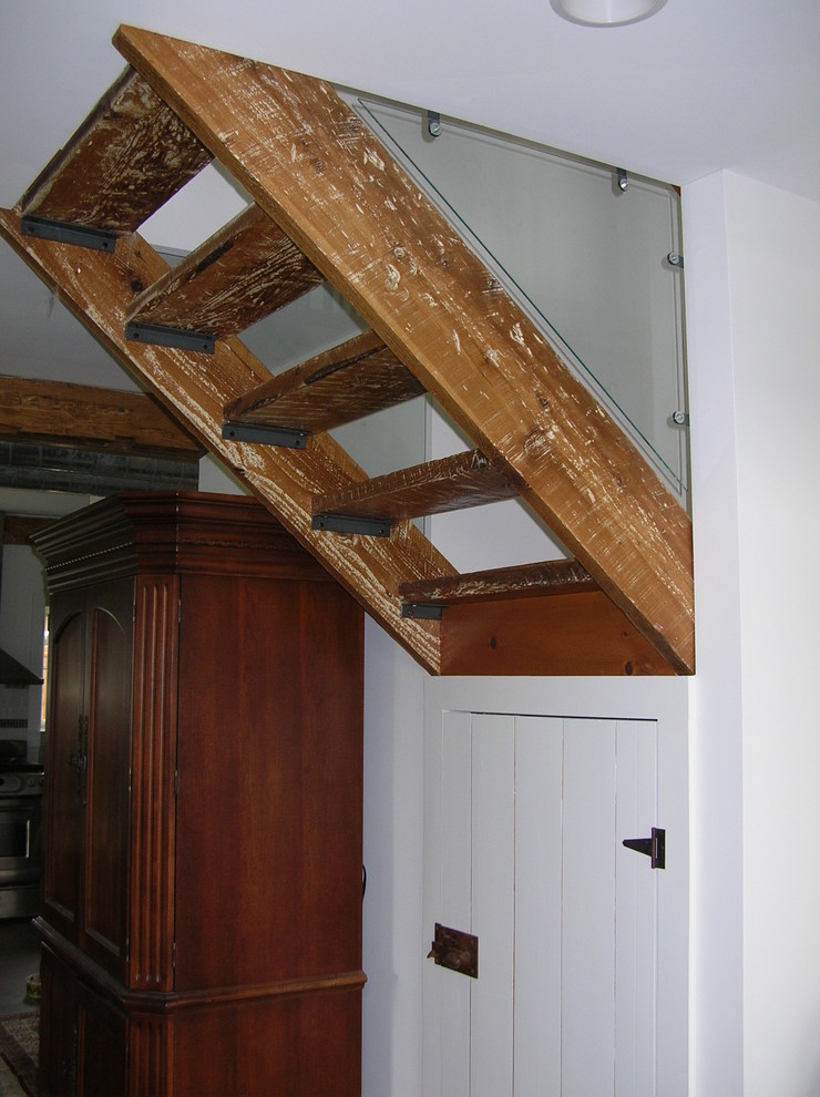 Design ideas for a mid-sized transitional wood floating staircase in Boston with open risers.