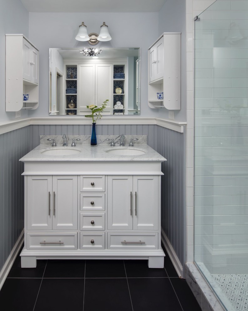 This is an example of a small traditional master bathroom in Philadelphia with white cabinets, gray tile, grey walls, porcelain floors, marble benchtops, black floor, white benchtops and recessed-panel cabinets.