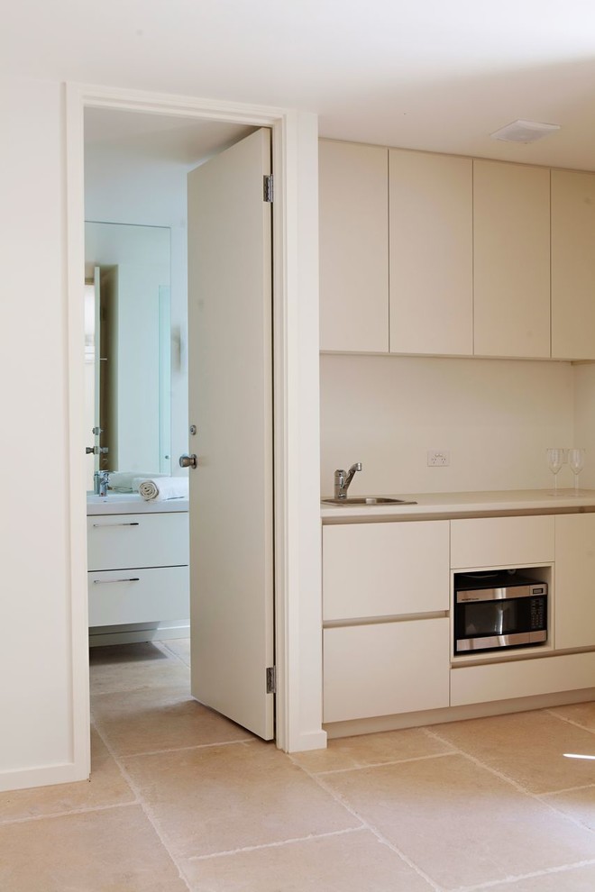 Large contemporary kitchen in Sydney with limestone floors.