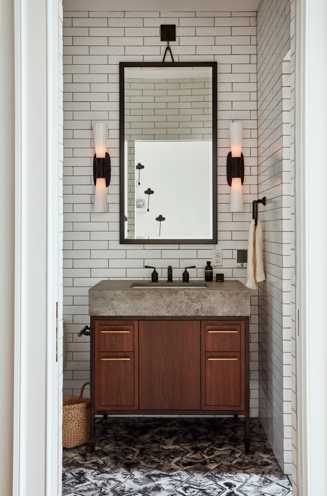 Transitional powder room in Philadelphia with flat-panel cabinets, dark wood cabinets, white tile, an undermount sink, grey floor and grey benchtops.
