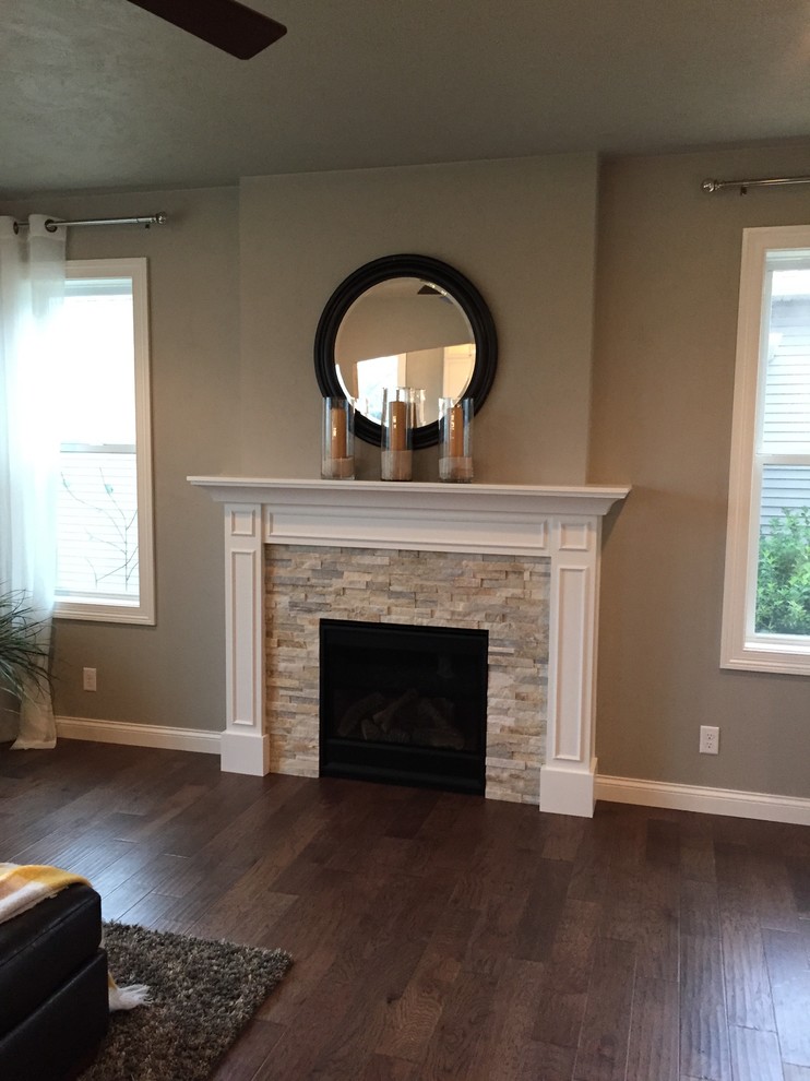 Mid-sized arts and crafts open concept living room in Other with grey walls, medium hardwood floors, a standard fireplace, a stone fireplace surround and a wall-mounted tv.