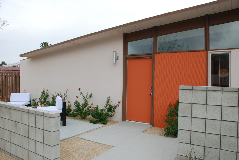 Design ideas for a midcentury entryway in Los Angeles with an orange front door.
