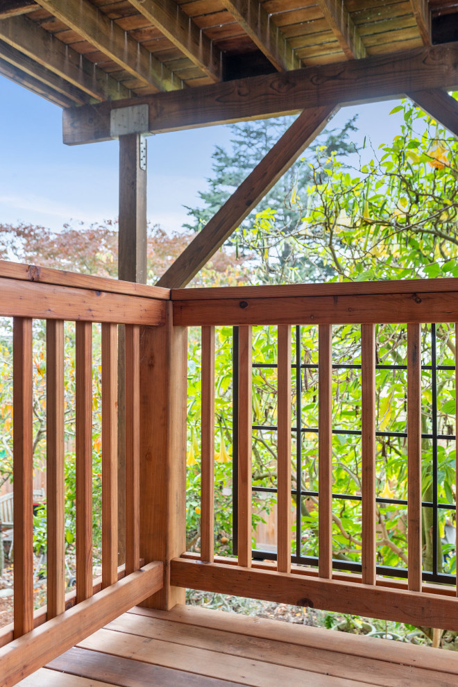 Example of a large mountain style backyard second story wood railing deck design in San Francisco with no cover