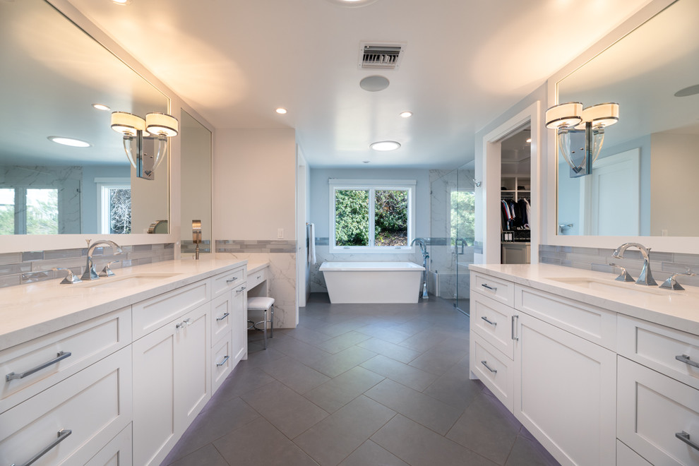 Design ideas for an expansive transitional master bathroom in Los Angeles with a freestanding tub, white walls, light hardwood floors, an undermount sink, engineered quartz benchtops and white benchtops.