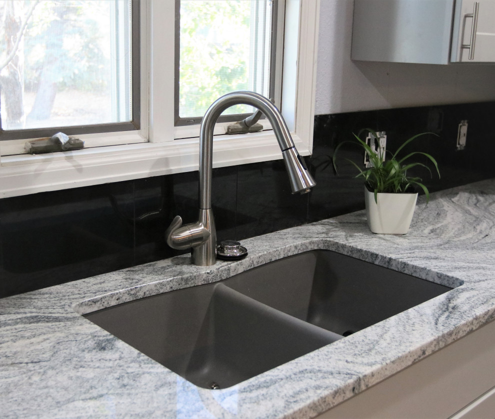 Example of a large u-shaped eat-in kitchen design in Other with an undermount sink, granite countertops, black backsplash and multicolored countertops