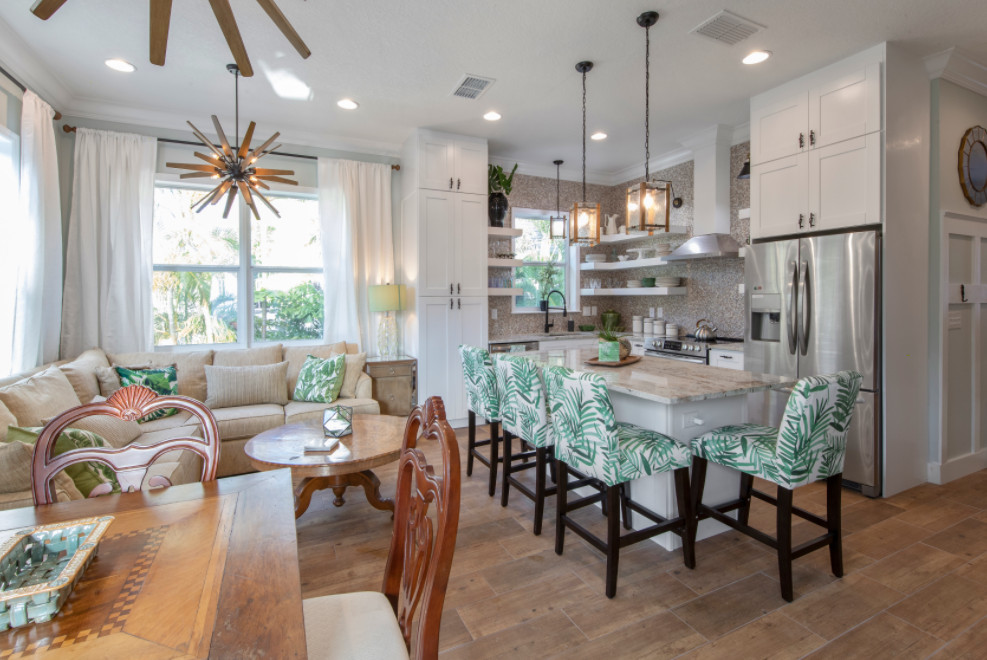 Design ideas for a beach style single-wall eat-in kitchen in Tampa with a drop-in sink, shaker cabinets, white cabinets, quartzite benchtops, multi-coloured splashback, stone tile splashback, stainless steel appliances, ceramic floors, with island, brown floor and multi-coloured benchtop.